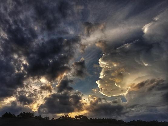 Clouds at sunset with dark clouds on the left and white clouds on the right